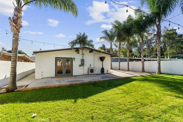 a front view of a house with a garden and yard