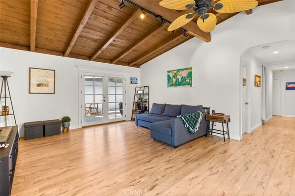 a living room with furniture and a wooden floor