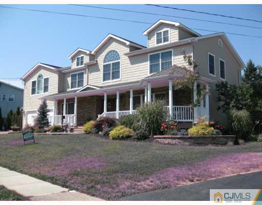 4 Putnam Road Howell, NJ 07731 - Photo 2 of 10 a front view of a house with garden and porch