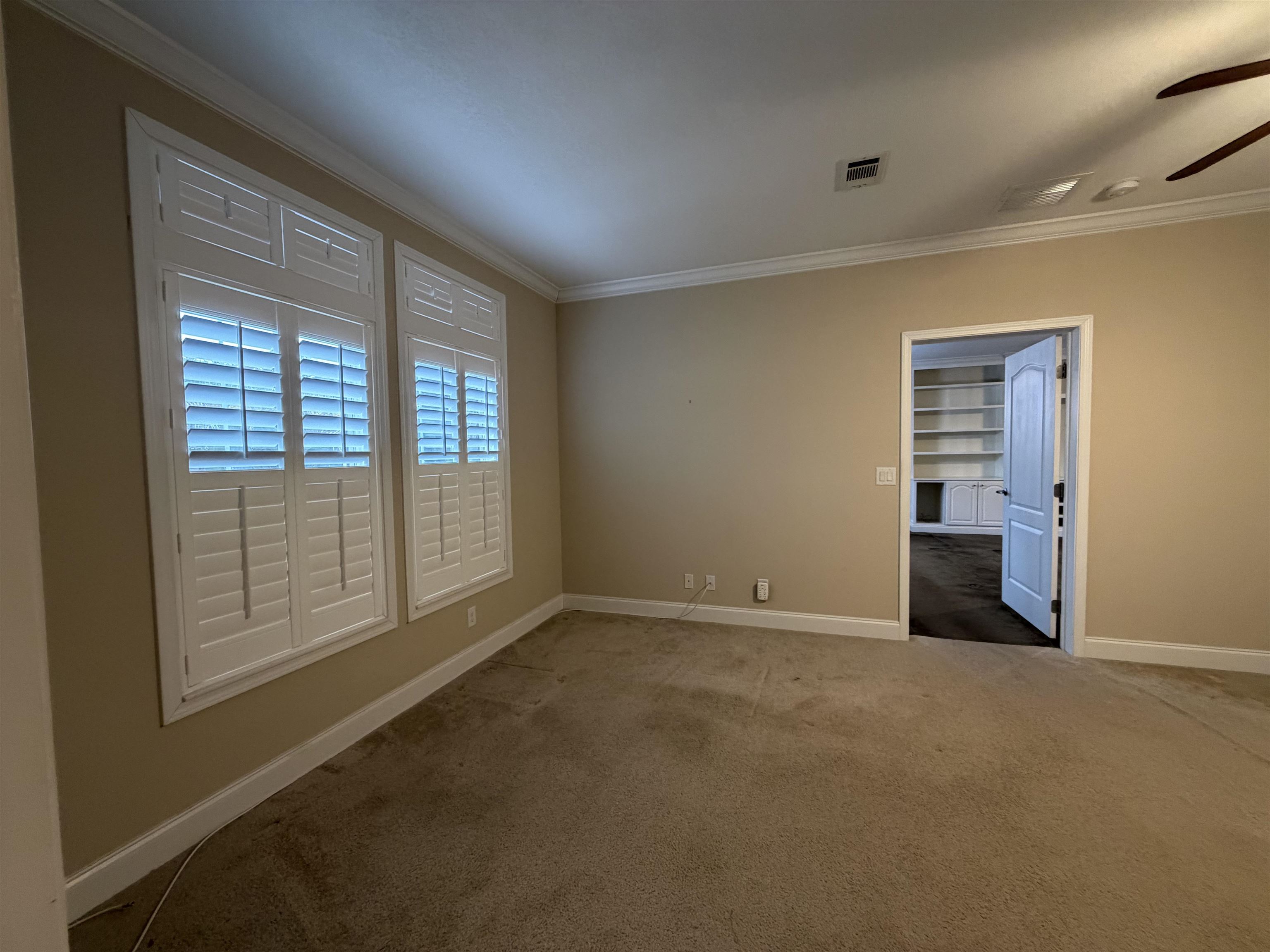 2434 Pellicer Road St. Augustine, FL 32092 - Photo 21 of 41 Carpeted spare room featuring ornamental molding and ceiling fan