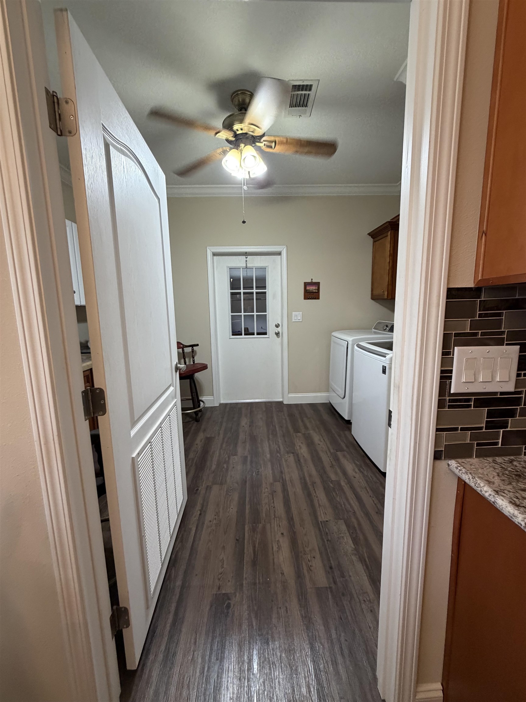 2434 Pellicer Road St. Augustine, FL 32092 - Photo 33 of 41 Corridor featuring dark wood-style floors, separate washer and dryer, and crown molding
