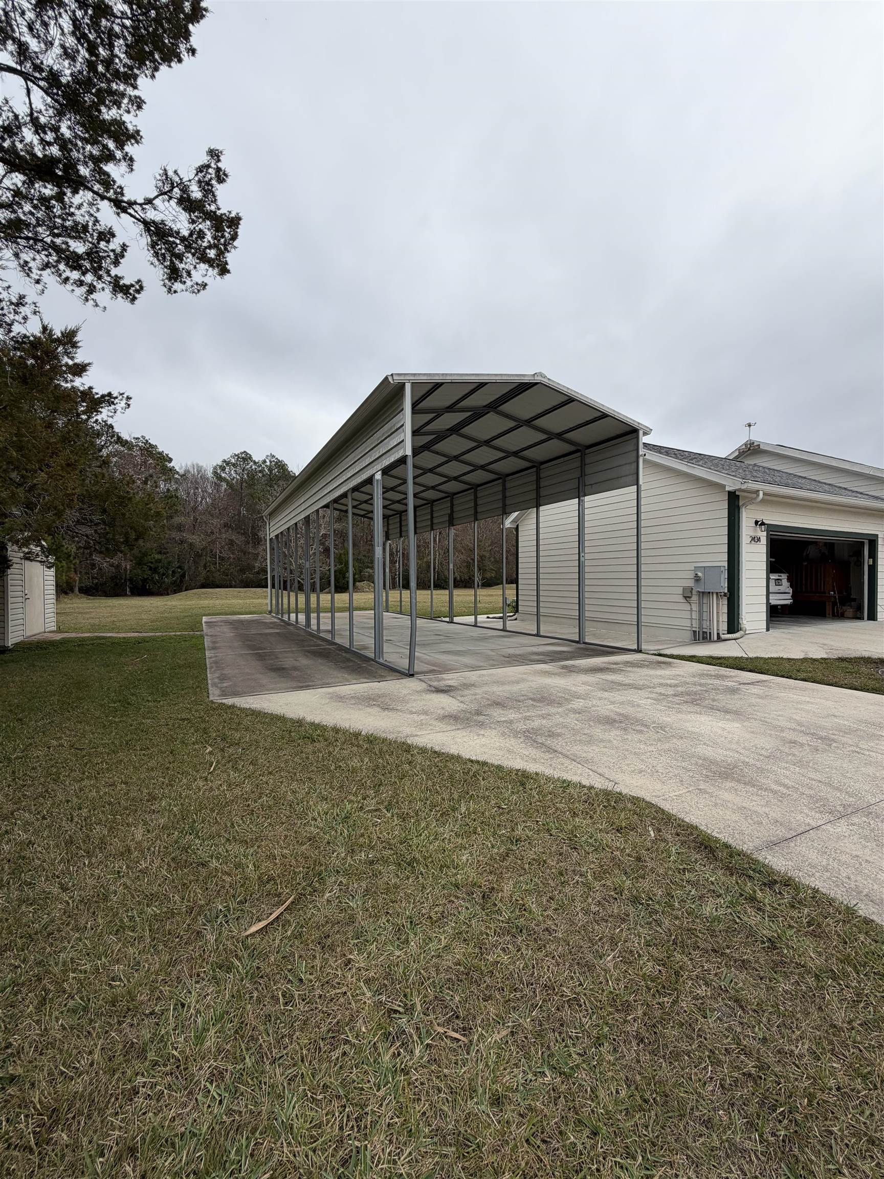2434 Pellicer Road St. Augustine, FL 32092 - Photo 37 of 41 Exterior space featuring driveway and a carport