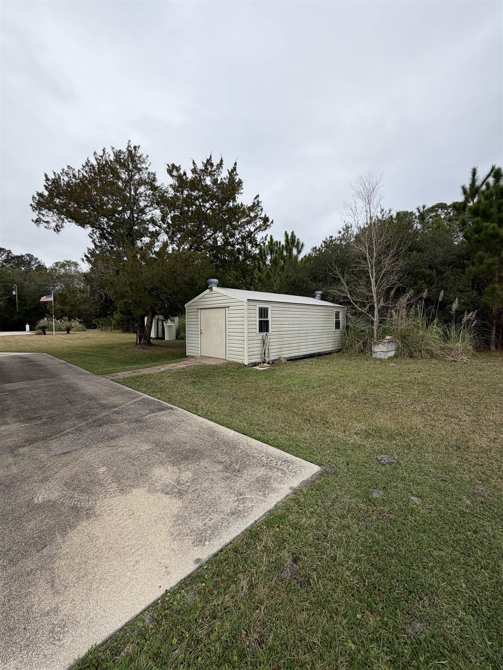 2434 Pellicer Road St. Augustine, FL 32092 - Photo 39 of 41 View of green lawn with an outbuilding