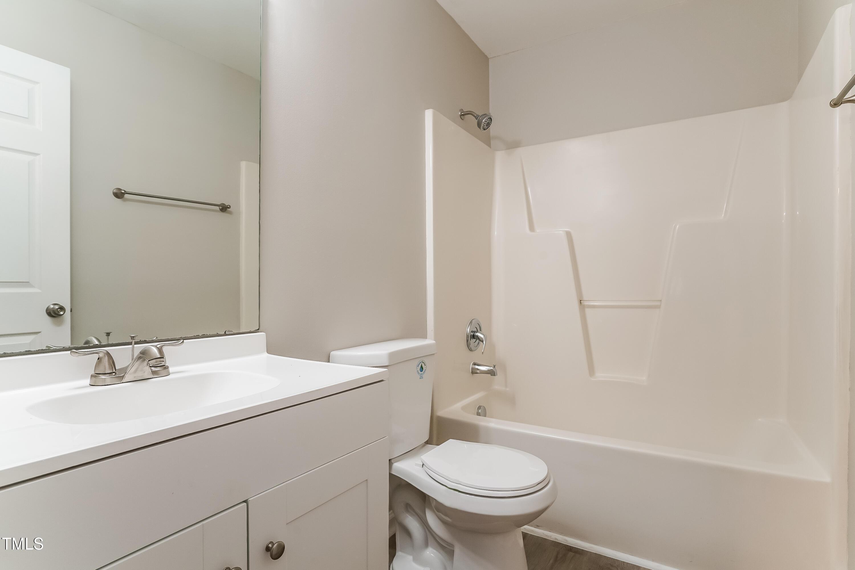 939 Rand Street Smithfield, NC 27577 - Photo 11 of 16 a bathroom with a sink a toilet and shower