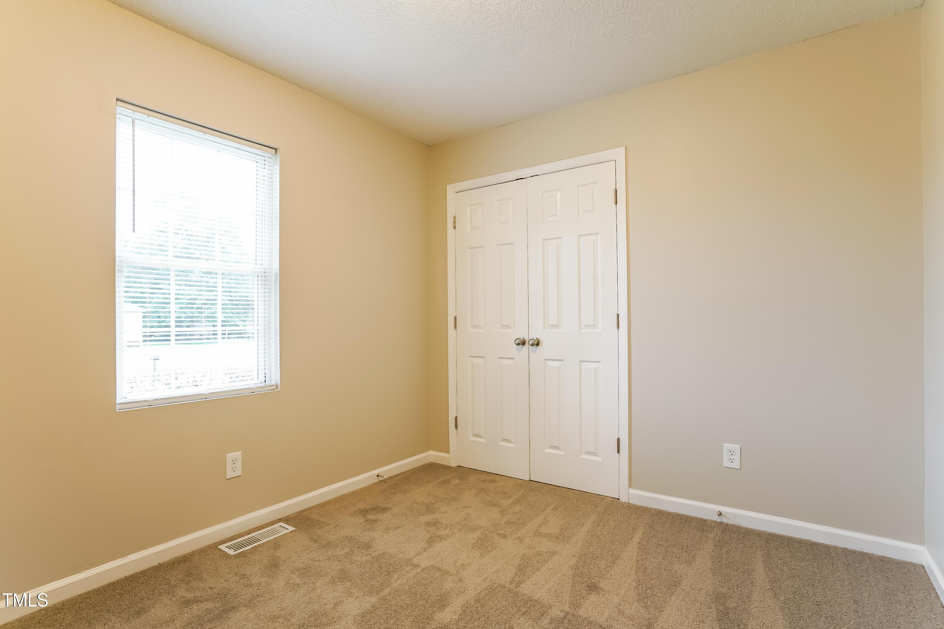 939 Rand Street Smithfield, NC 27577 - Photo 14 of 16 an empty room with windows