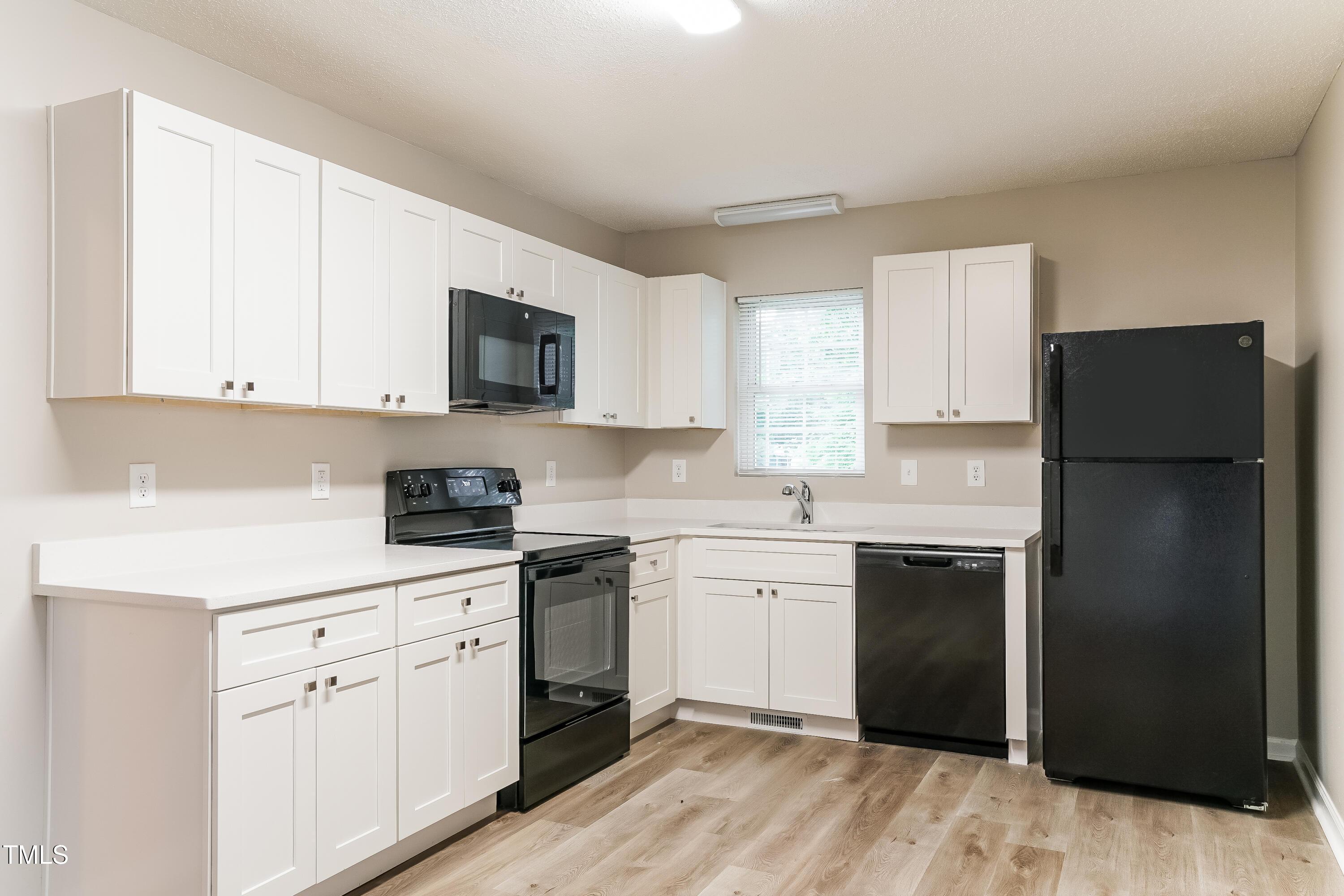 939 Rand Street Smithfield, NC 27577 - Photo 7 of 16 a kitchen with a refrigerator stove and sink