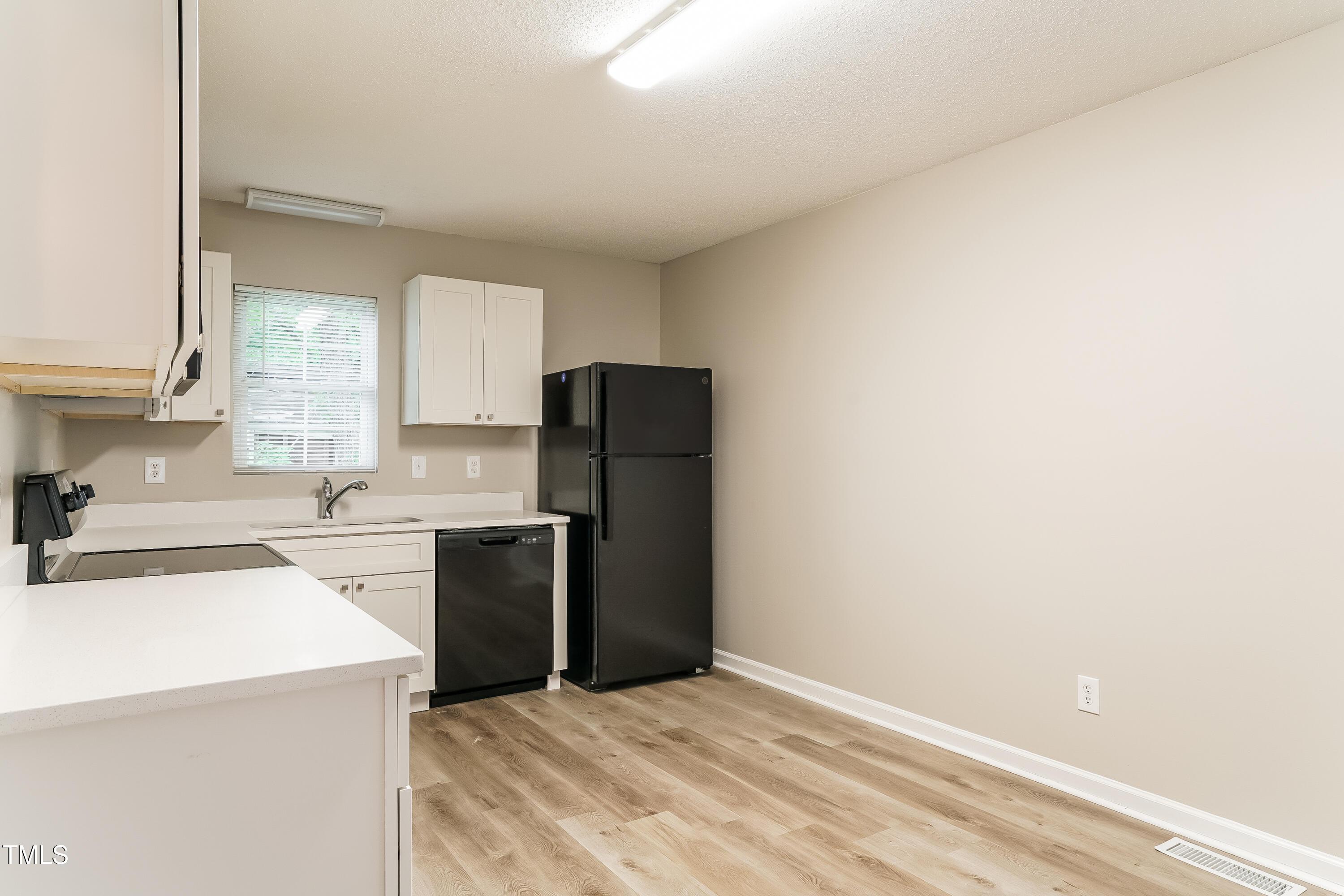 939 Rand Street Smithfield, NC 27577 - Photo 8 of 16 a kitchen with a refrigerator stove and sink