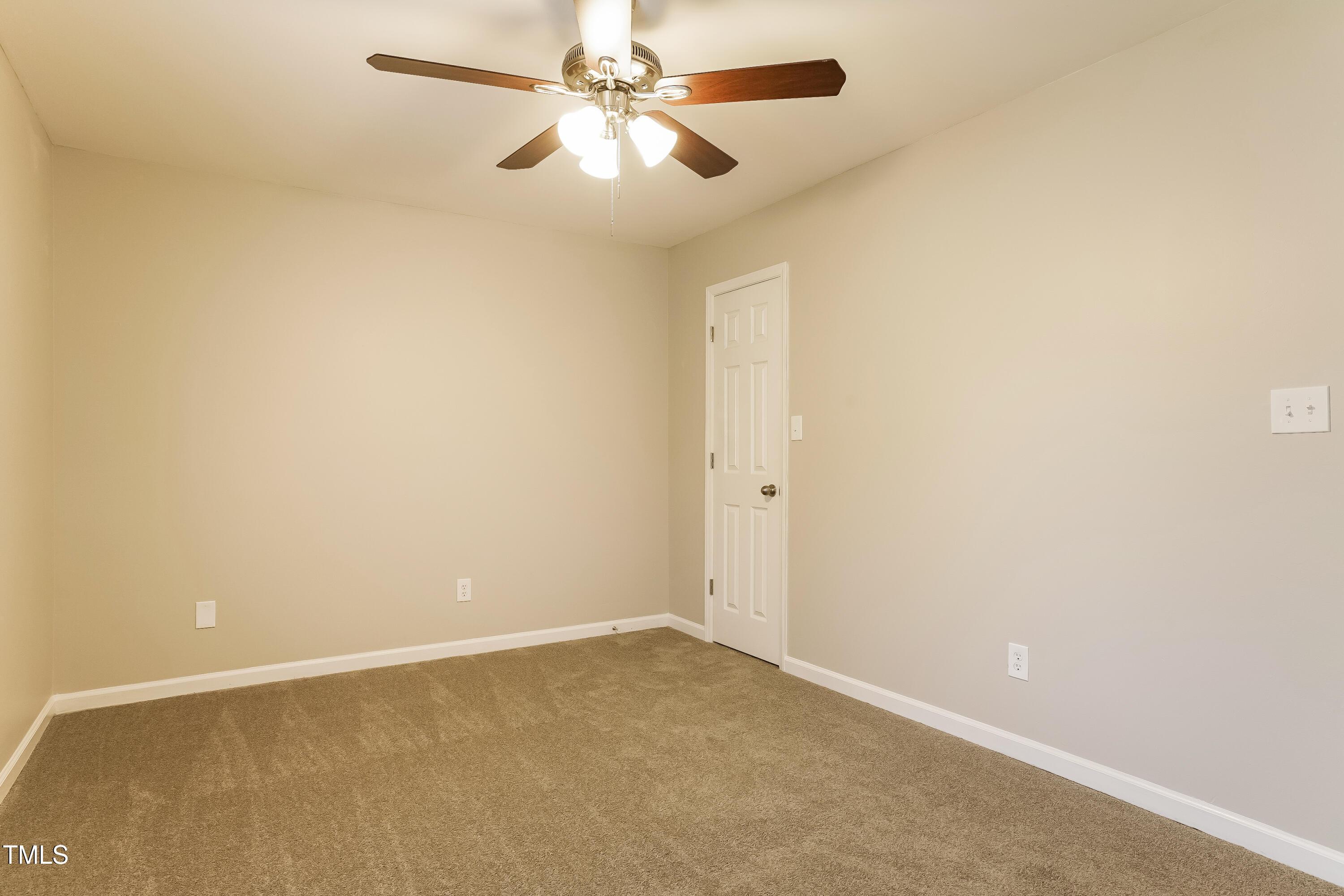 939 Rand Street Smithfield, NC 27577 - Photo 9 of 16 an empty room with a fan and a fan