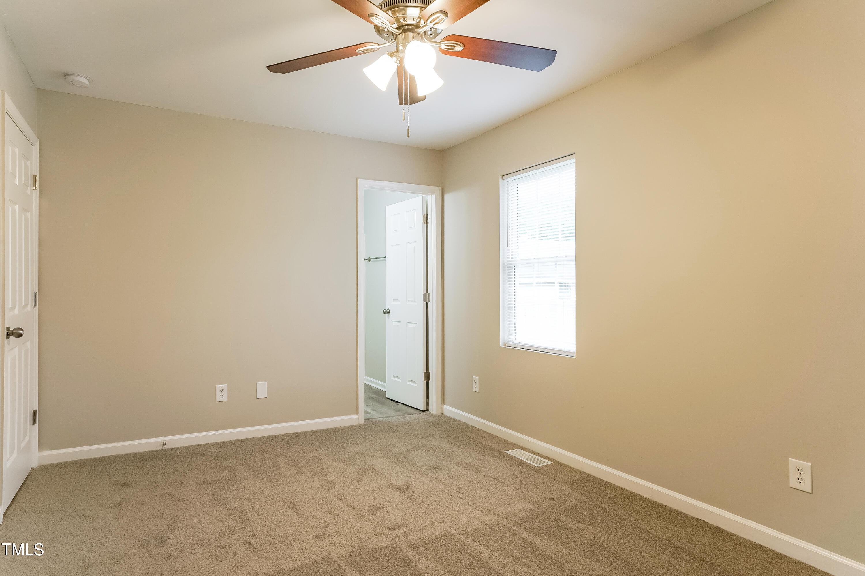 939 Rand Street Smithfield, NC 27577 - Photo 10 of 16 an empty room with windows and fan