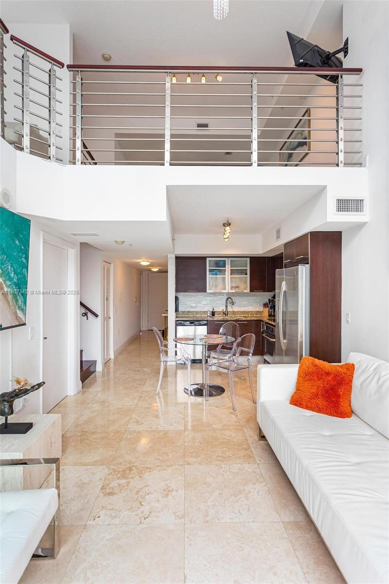 41 Southeast 5th Street, Unit 2008 Miami, FL 33131 - Photo 18 of 54 a living room with furniture and kitchen view