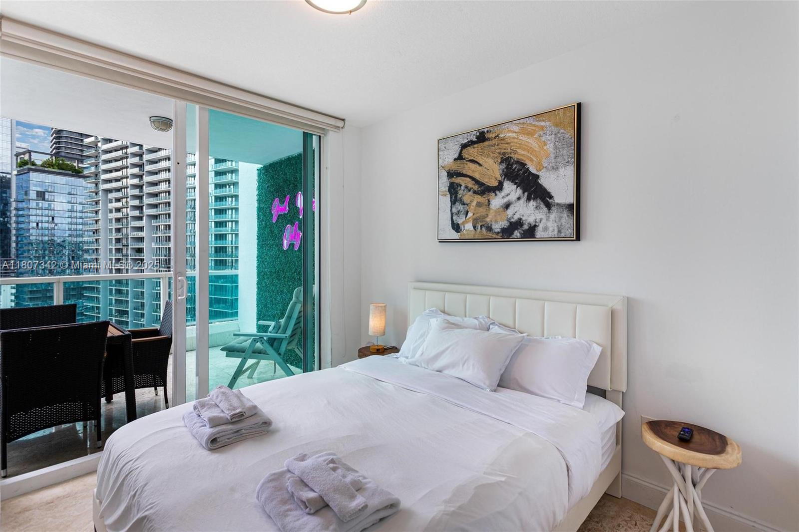 41 Southeast 5th Street, Unit 2008 Miami, FL 33131 - Photo 22 of 54 a bedroom with a bed and a desk