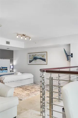a view of a balcony with a potted plants and a large tree