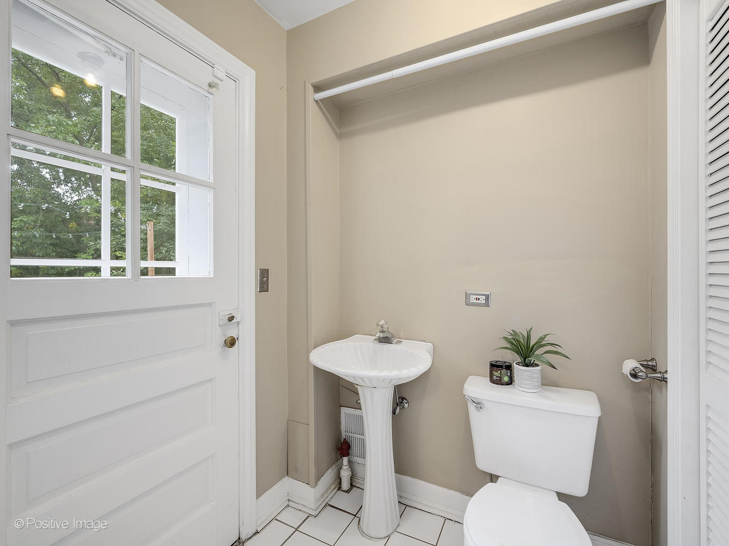337 Wagner Road Northfield, IL 60093 - Photo 16 of 22 a bathroom with a toilet a sink and a window