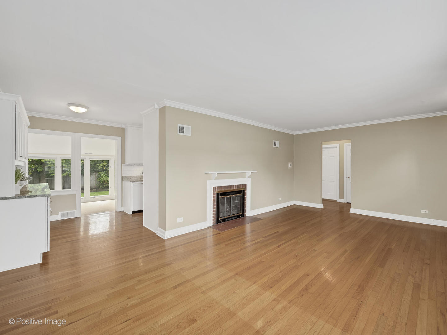 337 Wagner Road Northfield, IL 60093 - Photo 4 of 22 a view of empty room with wooden floor and fireplace