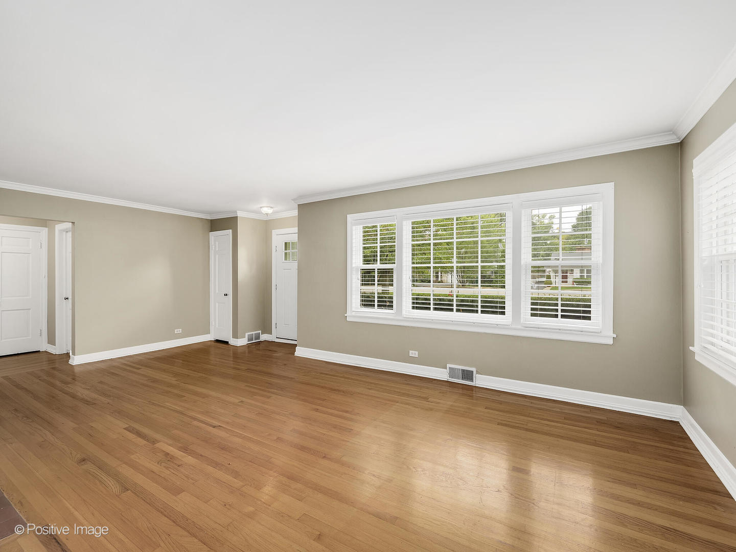 337 Wagner Road Northfield, IL 60093 - Photo 5 of 22 a view of an empty room with a window and wooden floor