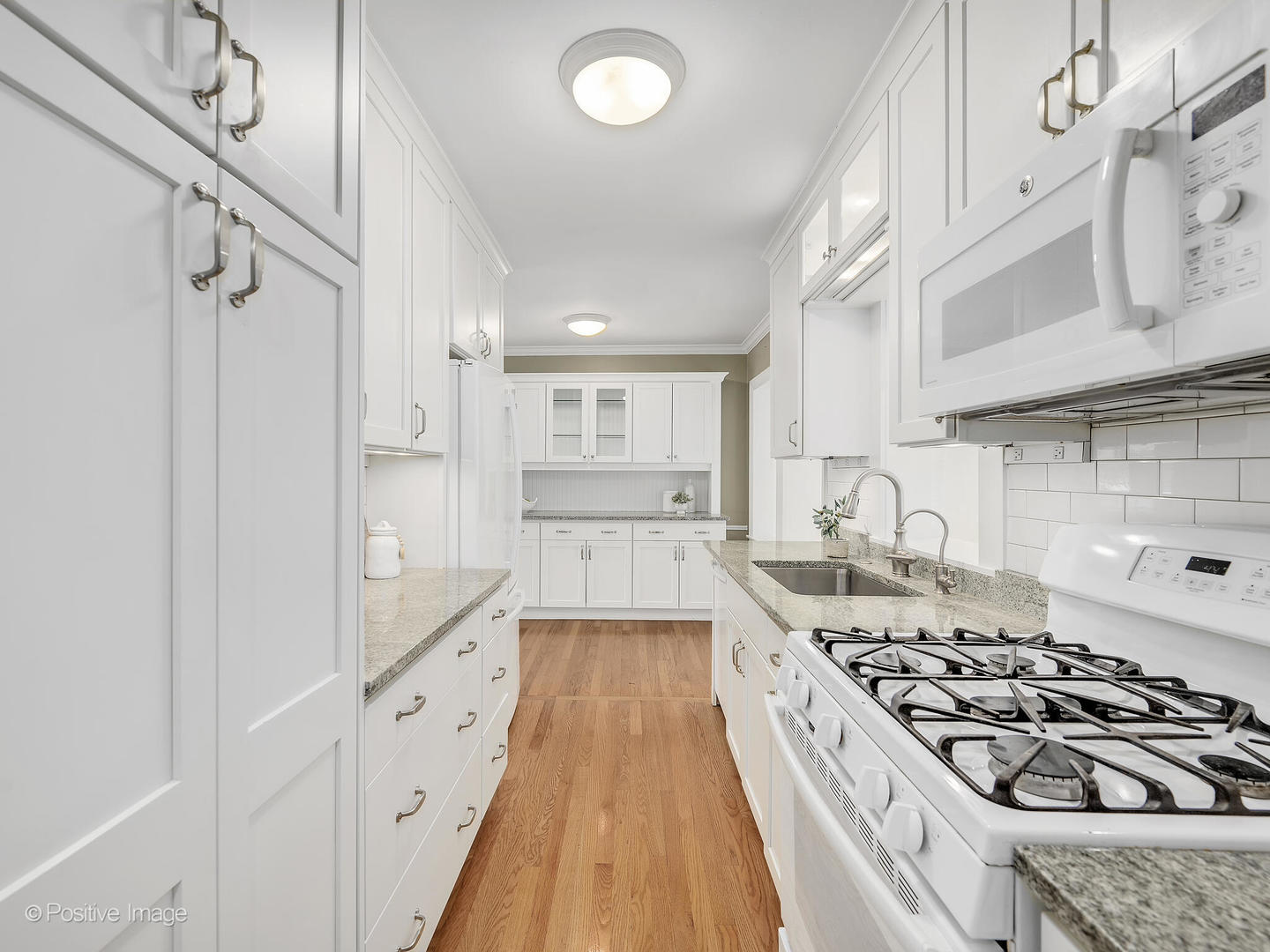 337 Wagner Road Northfield, IL 60093 - Photo 10 of 22 a kitchen with wooden floor and a stove top oven