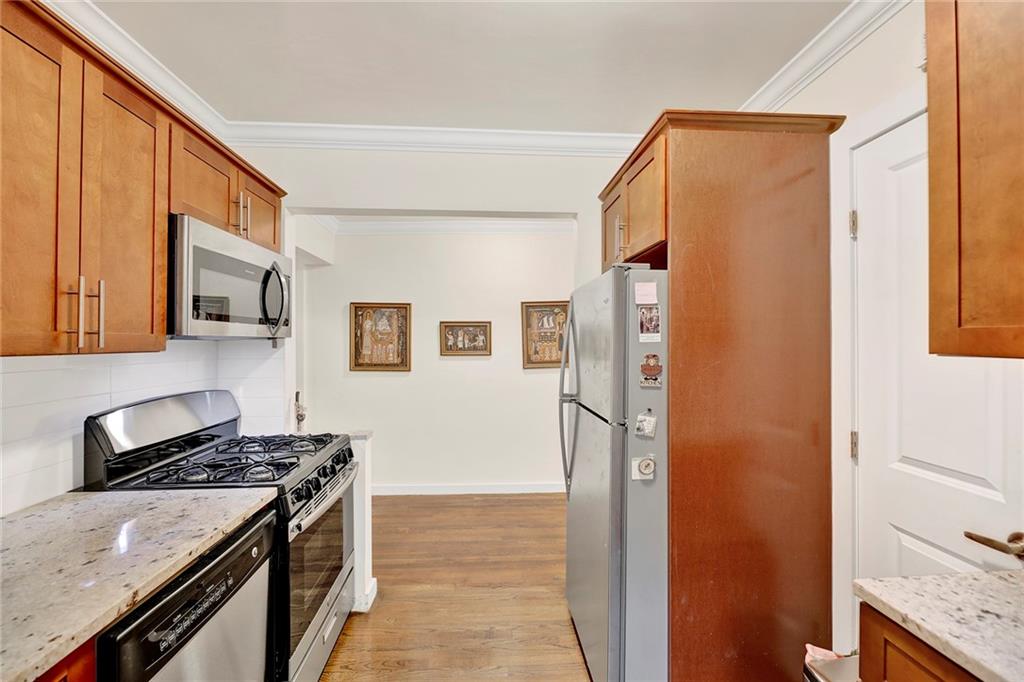 40 89th Street, Unit 4F Brooklyn, NY 11209 - Photo 12 of 22 a kitchen with stainless steel appliances granite countertop a refrigerator and a stove top oven