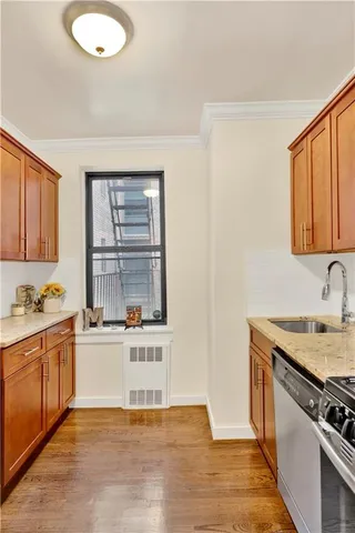 a kitchen with a sink stove and cabinets