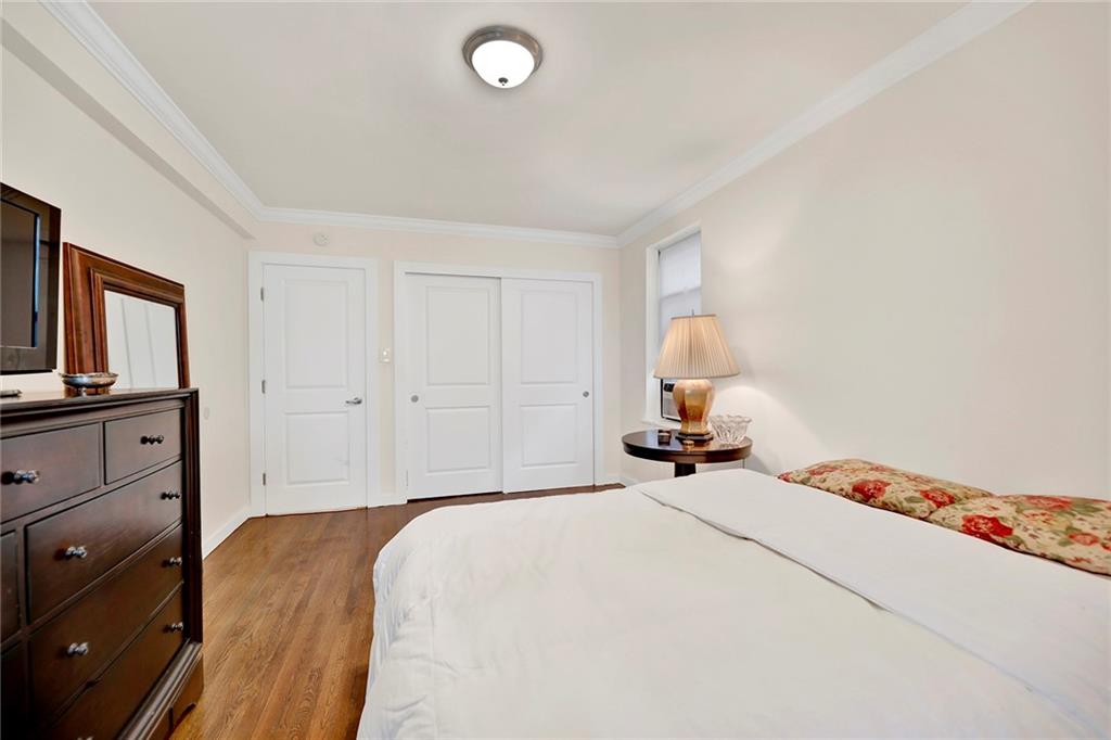 40 89th Street, Unit 4F Brooklyn, NY 11209 - Photo 16 of 22 a bedroom with a bed and wooden floor