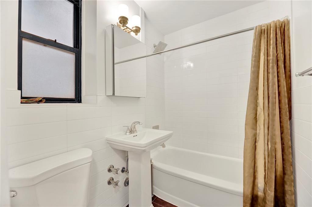 40 89th Street, Unit 4F Brooklyn, NY 11209 - Photo 17 of 22 a bathroom with a sink a toilet and shower
