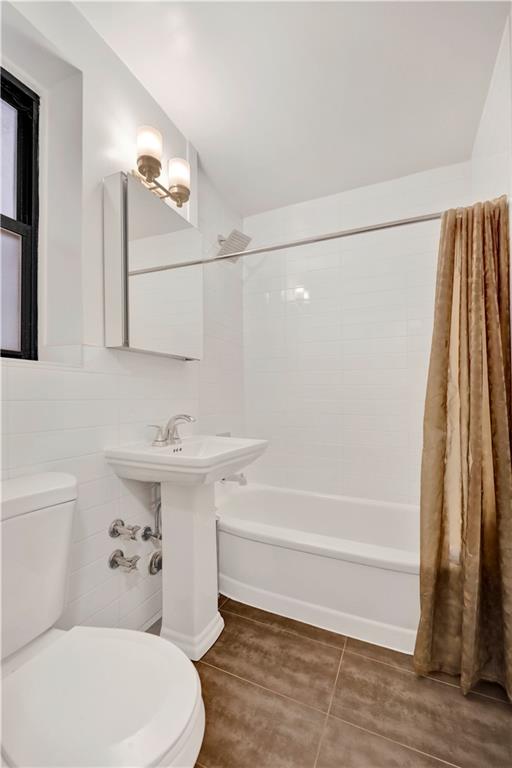 40 89th Street, Unit 4F Brooklyn, NY 11209 - Photo 18 of 22 a bathroom with a sink a toilet and shower
