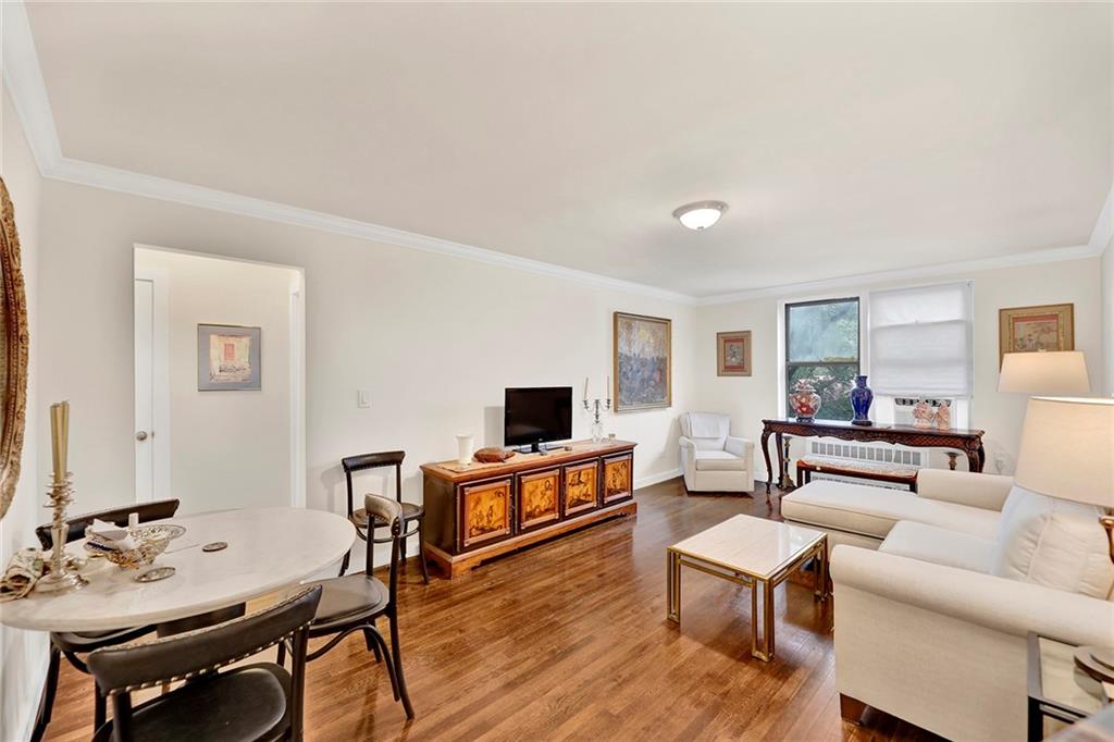 40 89th Street, Unit 4F Brooklyn, NY 11209 - Photo 4 of 22 a living room with furniture and a flat screen tv