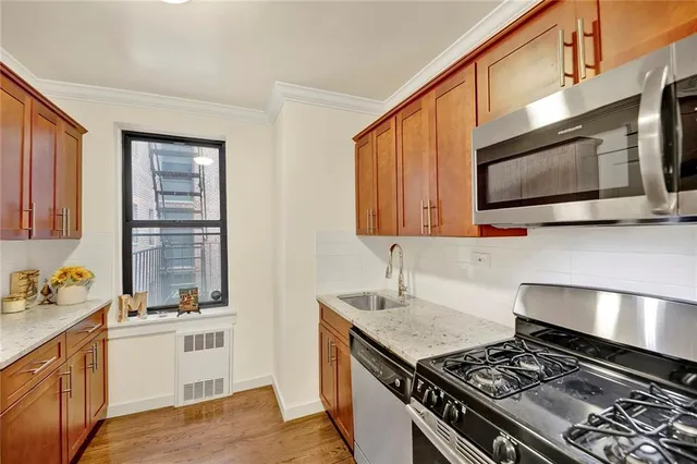 a kitchen with stainless steel appliances granite countertop a stove and a microwave