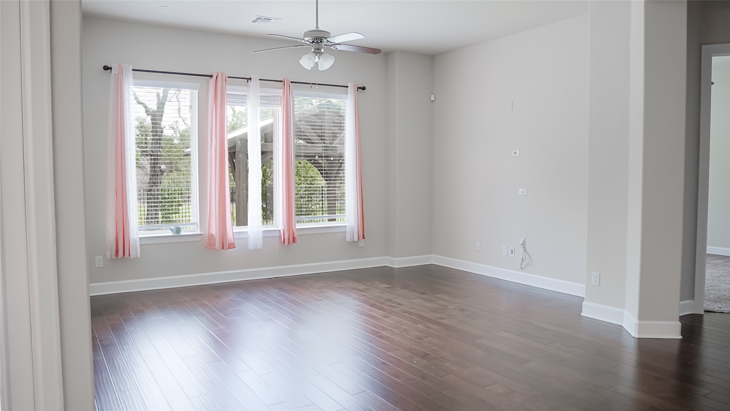 184 Fort Cobb Way Georgetown, TX 78628 - Photo 17 of 33 a view of empty room with wooden floor and fan