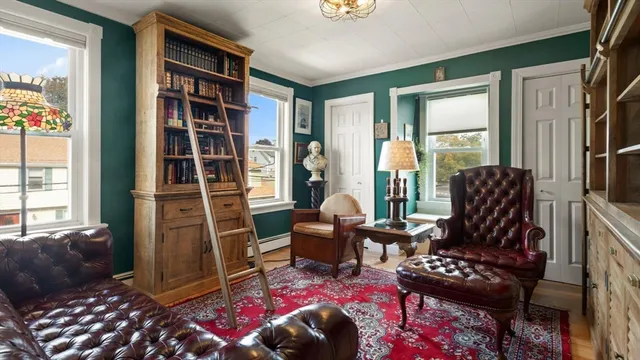 a living room with furniture a rug and a window