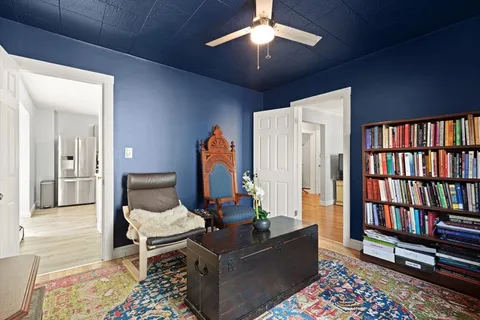 a living room with furniture and a book shelf