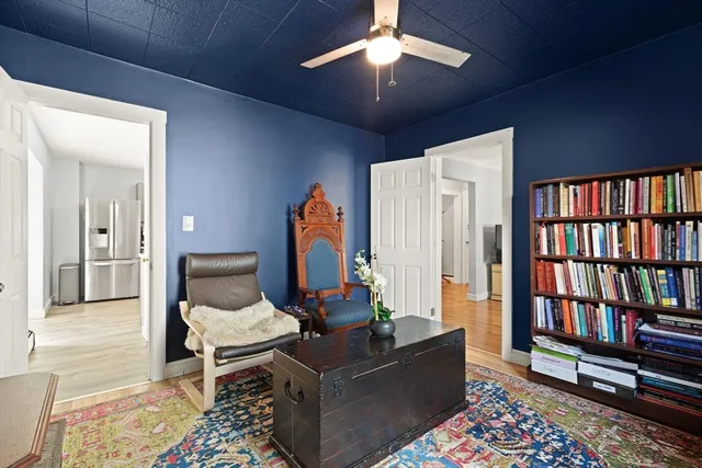 a living room with furniture and a book shelf