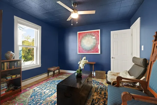 a living room with furniture piano and a window