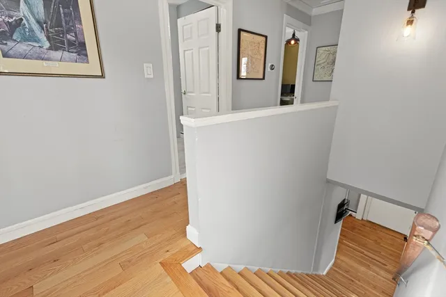 a view of a bedroom with wooden floor and hallway