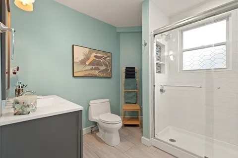 a white toilet sitting next to a bathroom sink