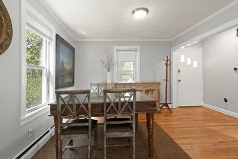 a view of a dining room with furniture and window