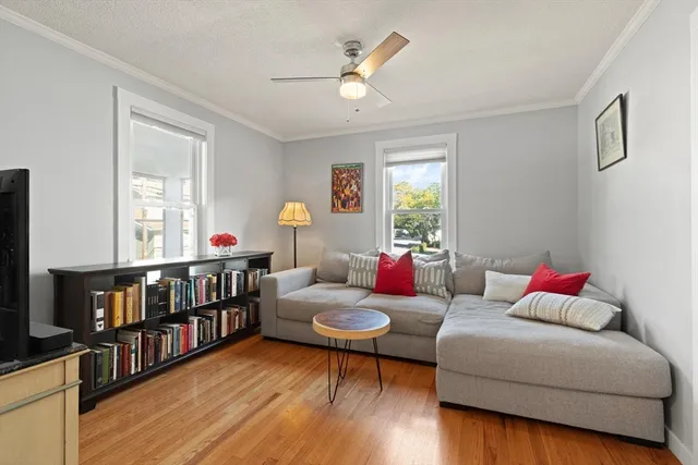 a living room with furniture a window and a flat screen tv