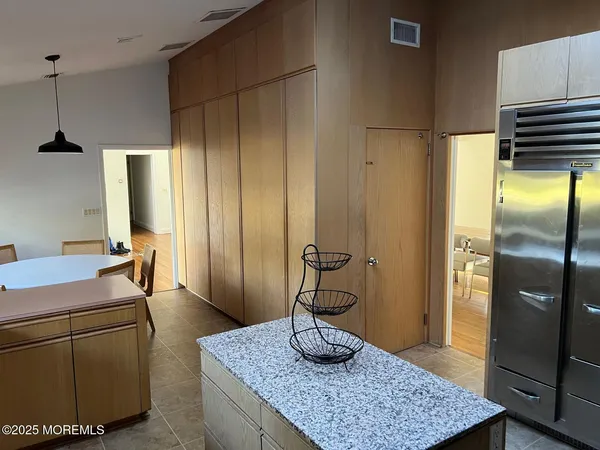 a room with a refrigerator and a table