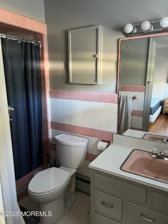 a bathroom with a toilet sink and mirror