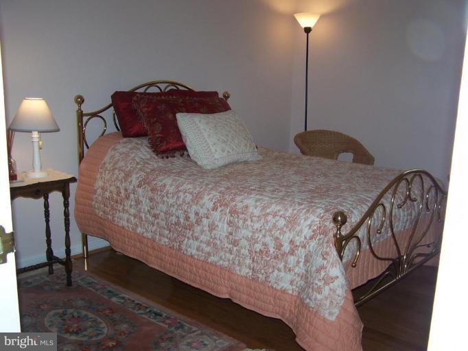 1029 Metfield Road Towson, MD 21286 - Photo 22 of 27 a bedroom with a bed and a chandelier