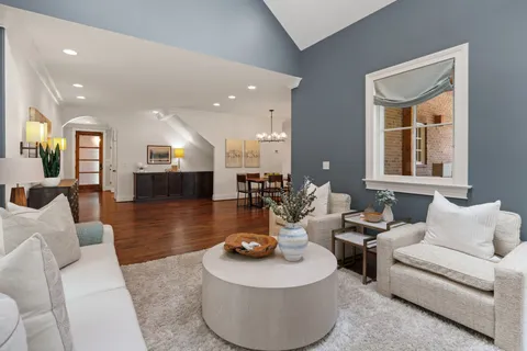 a kitchen with stainless steel appliances granite countertop a kitchen island hardwood floor and a sink