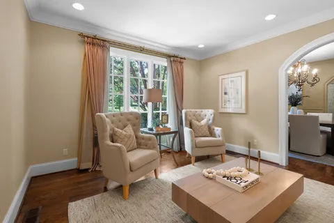 an empty room with wooden floor and a ceiling fan