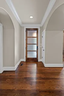 a bed sitting in a spacious bedroom next to a window