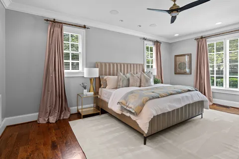 a spacious bedroom with a bed and a chandelier