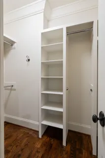 a view of walk in closet with empty racks