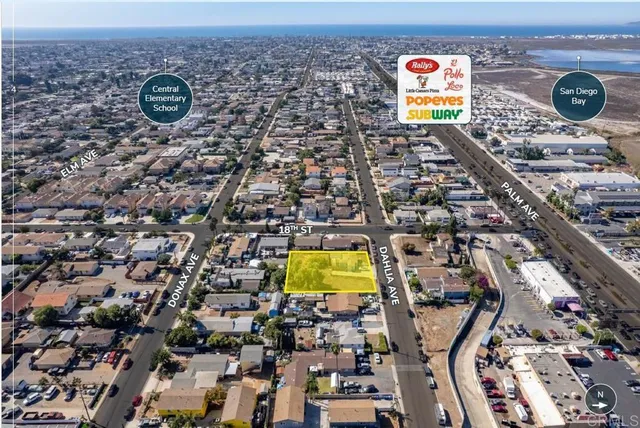 an aerial view of residential houses with outdoor space and parking