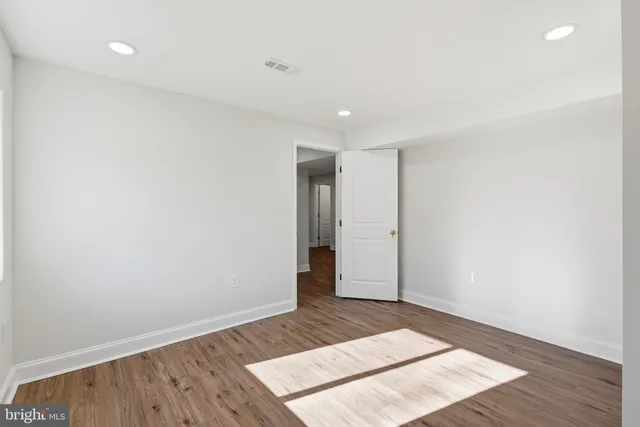 an empty room with wooden floor