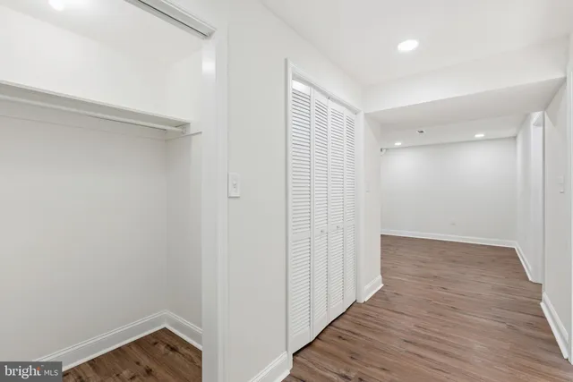 a view of a hallway with wooden floor