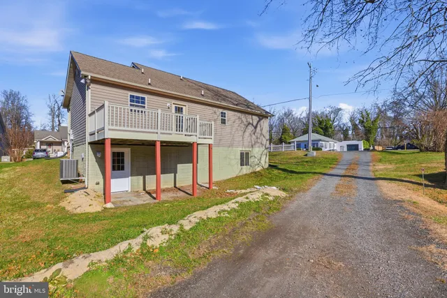 a view of a house with a yard patio and tree