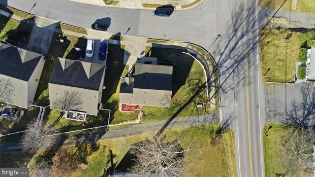 an aerial view of residential houses with outdoor space and seating area