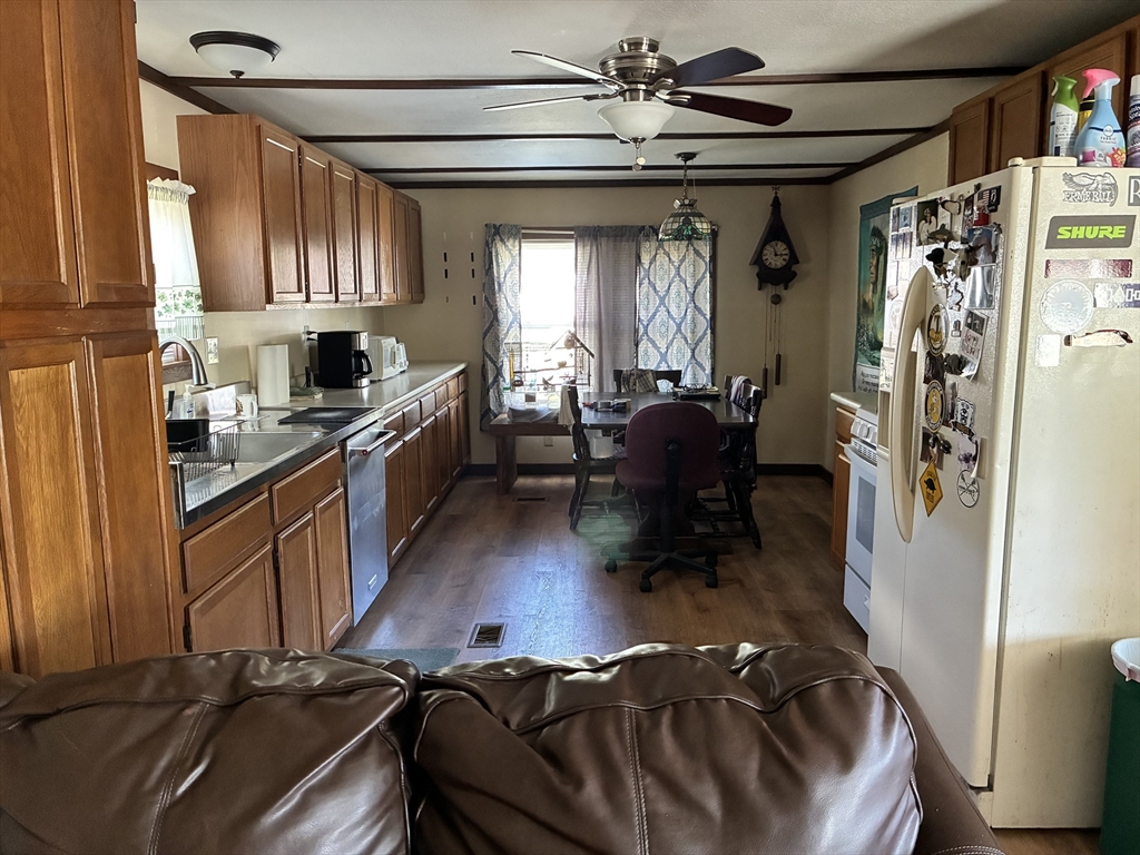 559 Tea Street, Unit 1 Charlemont, MA 01339 - Photo 5 of 14 a living room with stainless steel appliances furniture and a chandelier